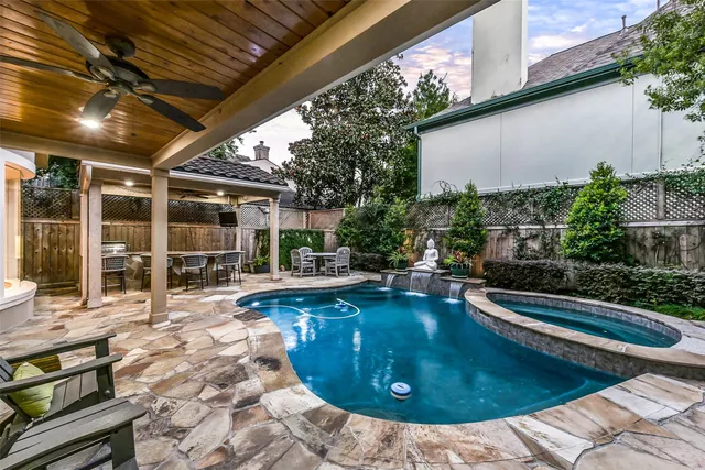 a view of a swimming pool with sitting area