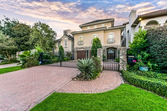 a front view of a house with a yard and potted plants
