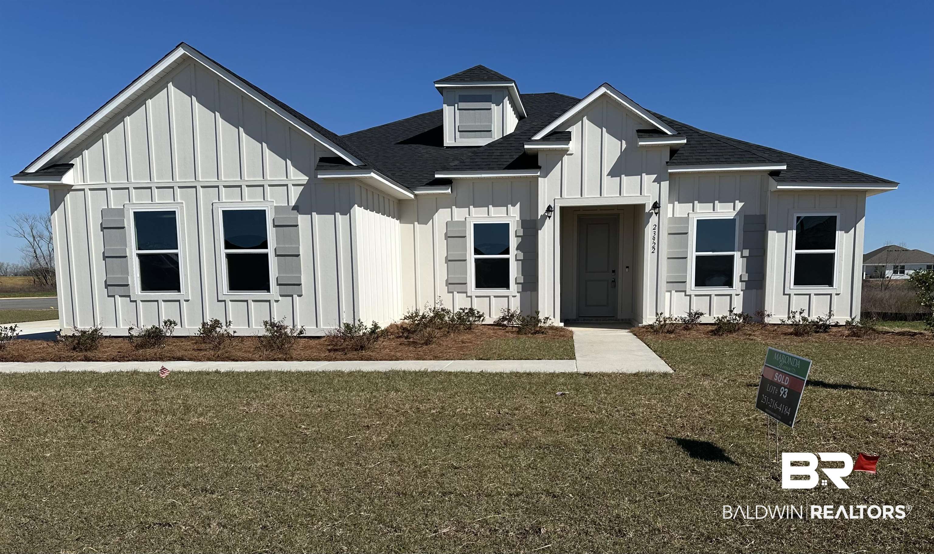 23922 Lafite Circle Daphne, AL 36526 - Photo 1 of 1 Modern inspired farmhouse featuring board and batten siding, roof with shingles, and a front lawn