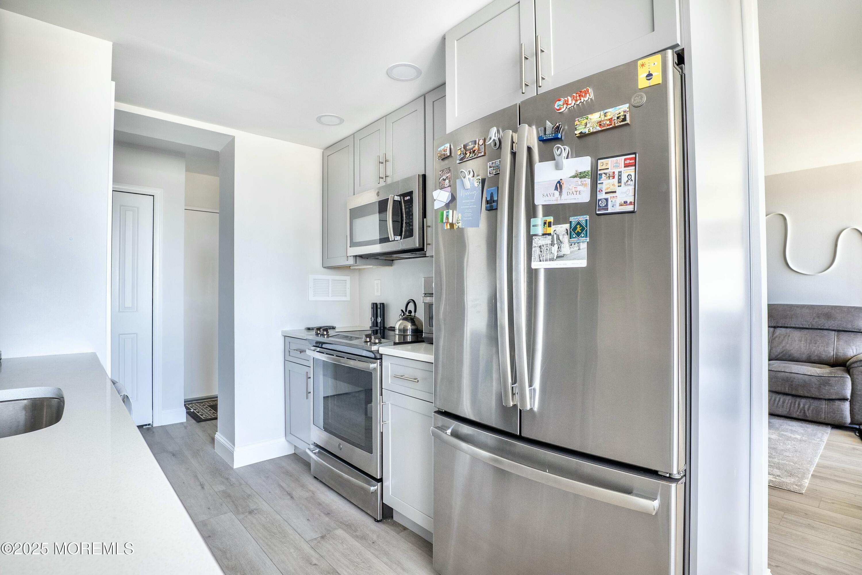 1000 River Road, Unit 6G Belmar, NJ 07719 - Photo 3 of 9 a kitchen with stainless steel appliances a refrigerator sink and stove