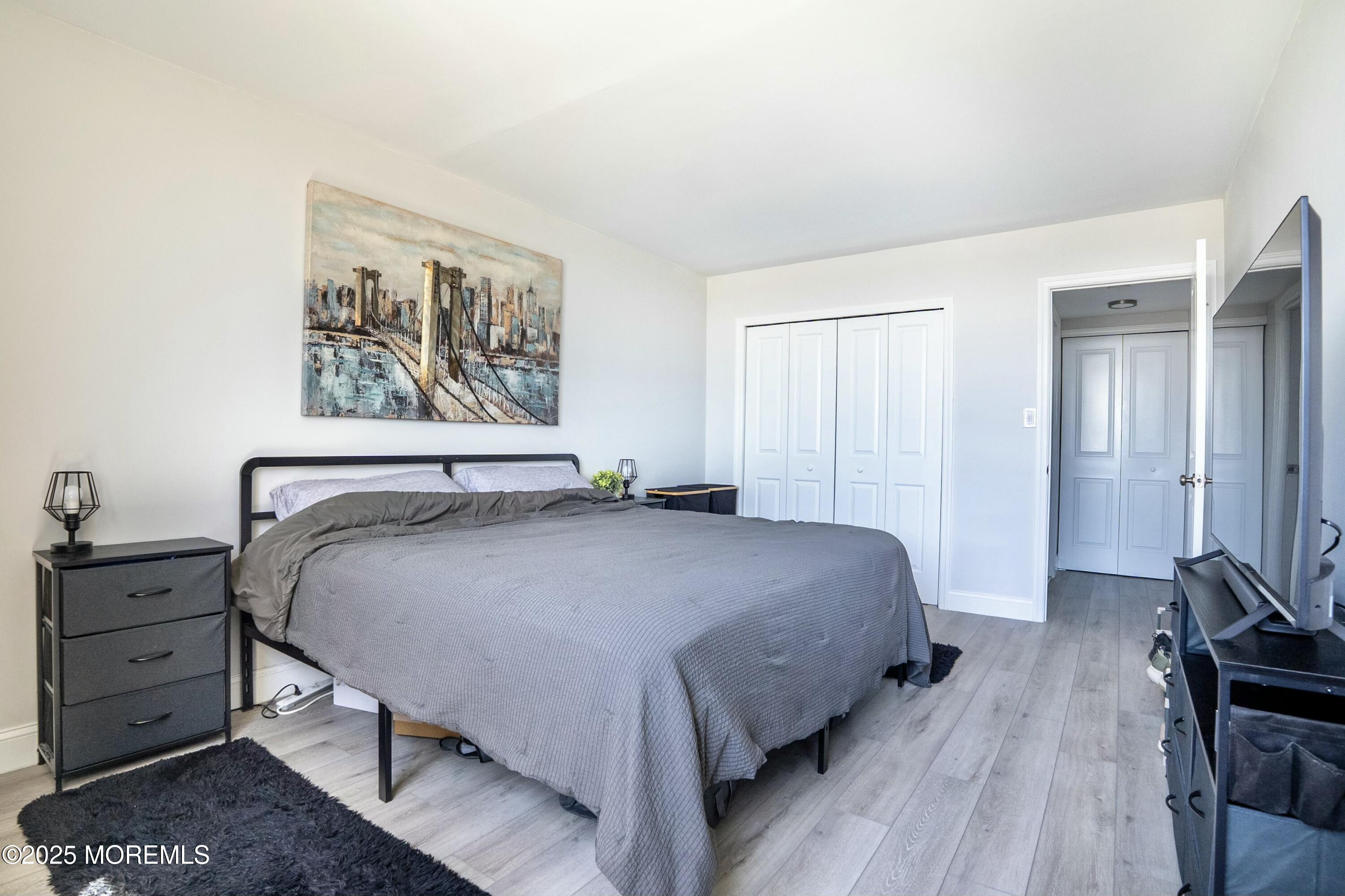 1000 River Road, Unit 6G Belmar, NJ 07719 - Photo 5 of 9 a bedroom with a bed and a furniture