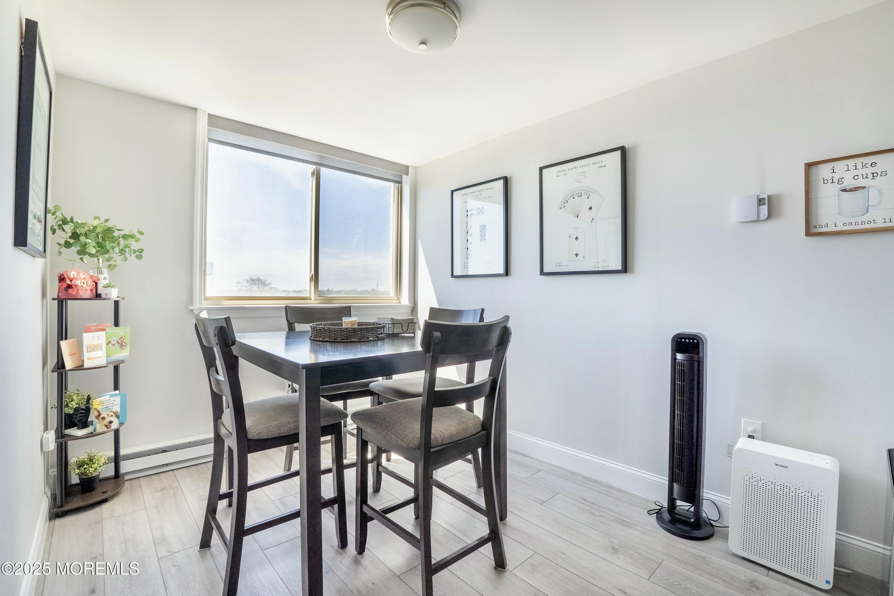 1000 River Road, Unit 6G Belmar, NJ 07719 - Photo 8 of 9 a view of a dining room with furniture and wooden floor