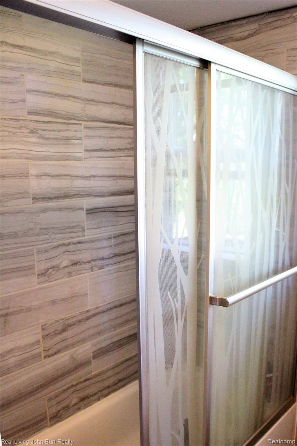 4965 Perryville Road Holly, MI 48442 - Photo 13 of 29 Main hallway bathroom shower, beautiful tile and door