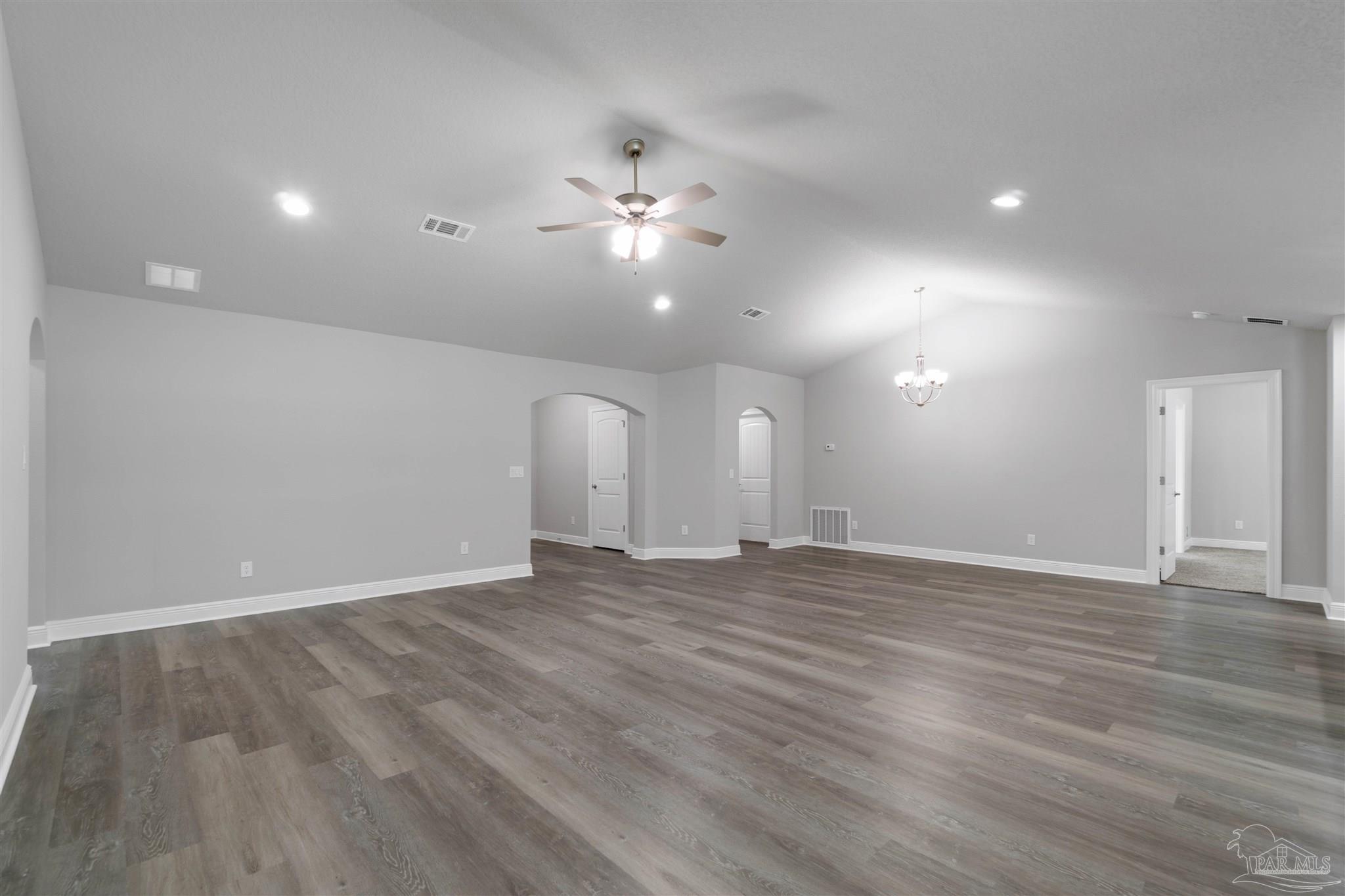 4289 Carl Booker Road Milton, FL 32583 - Photo 11 of 40 a view of an empty room with chandelier fan and wooden floor
