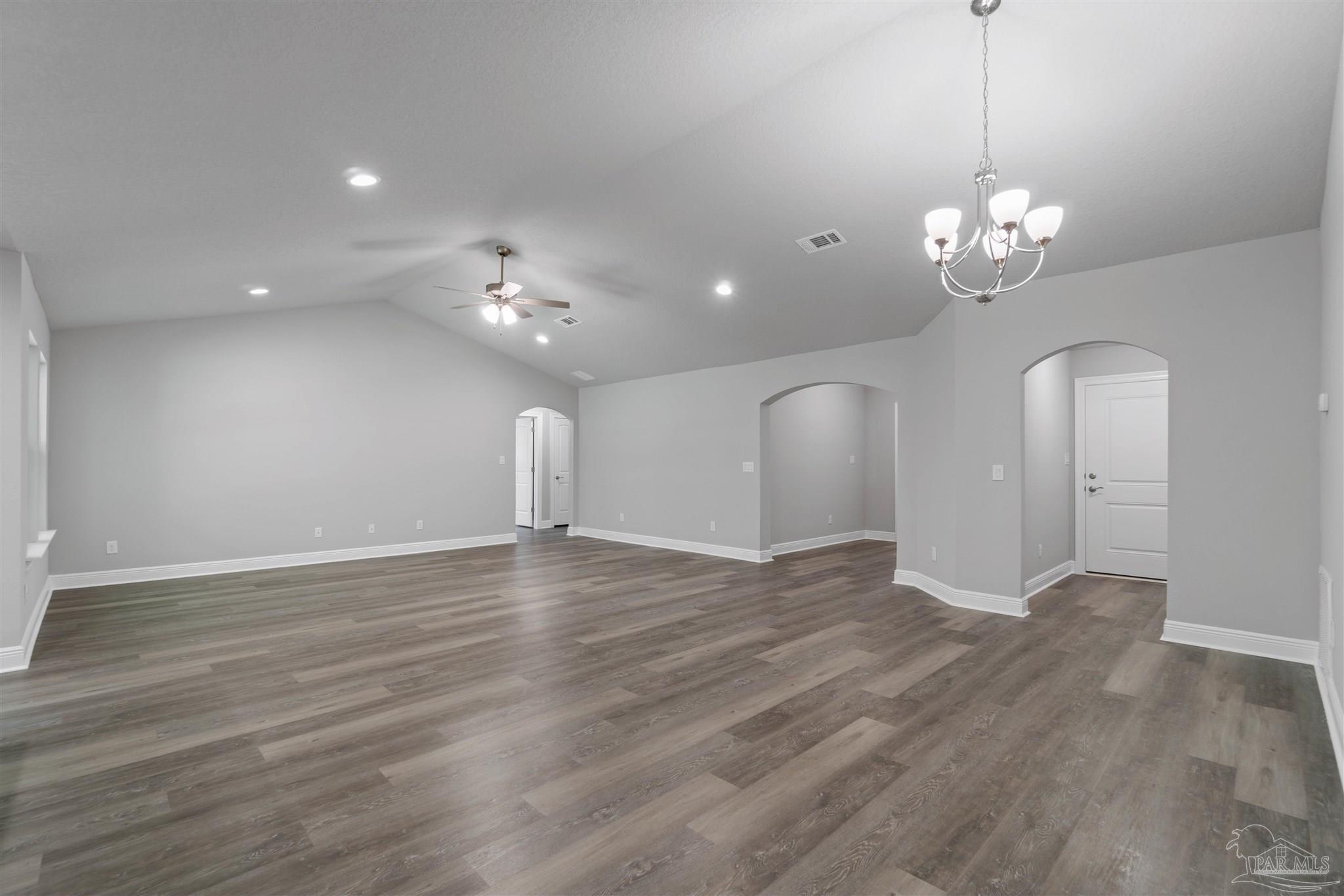 4289 Carl Booker Road Milton, FL 32583 - Photo 12 of 40 a view of an empty room with a chandelier fan and wooden floor