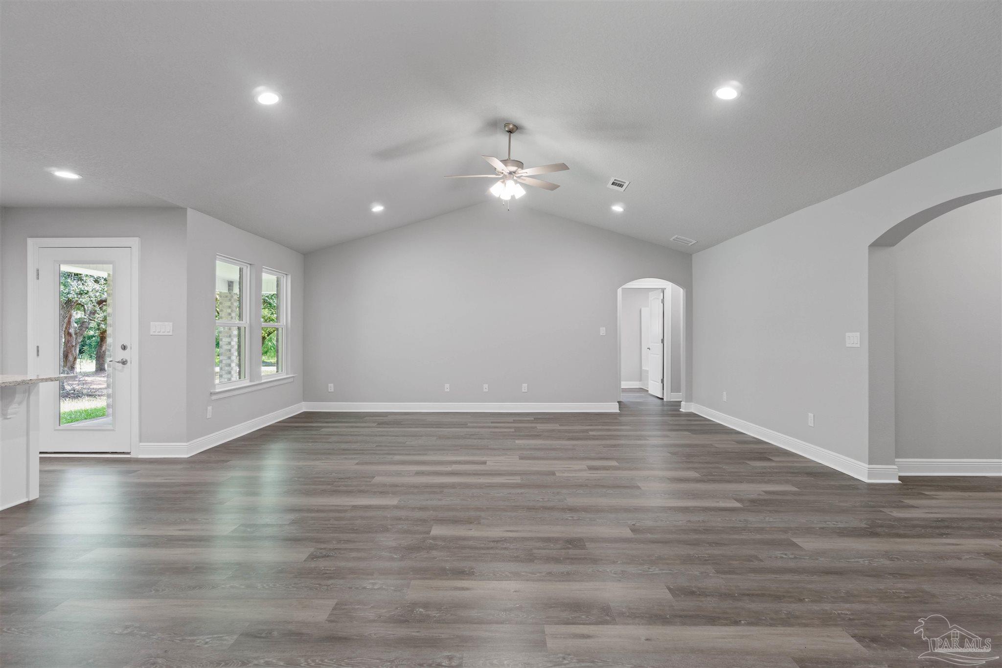 4289 Carl Booker Road Milton, FL 32583 - Photo 13 of 40 a view of an empty room with window and wooden floor