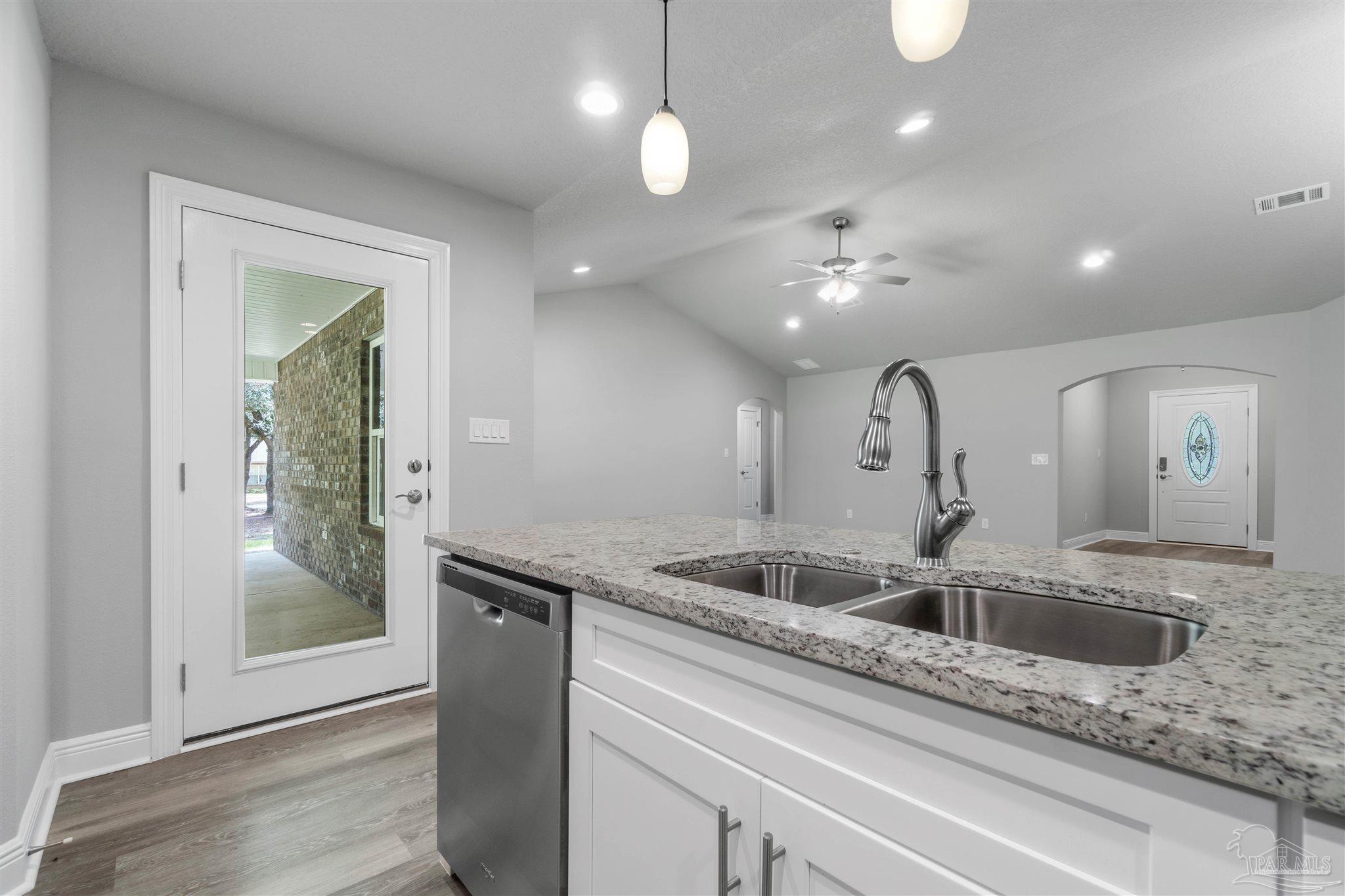 4289 Carl Booker Road Milton, FL 32583 - Photo 19 of 40 a kitchen with a sink and chandelier