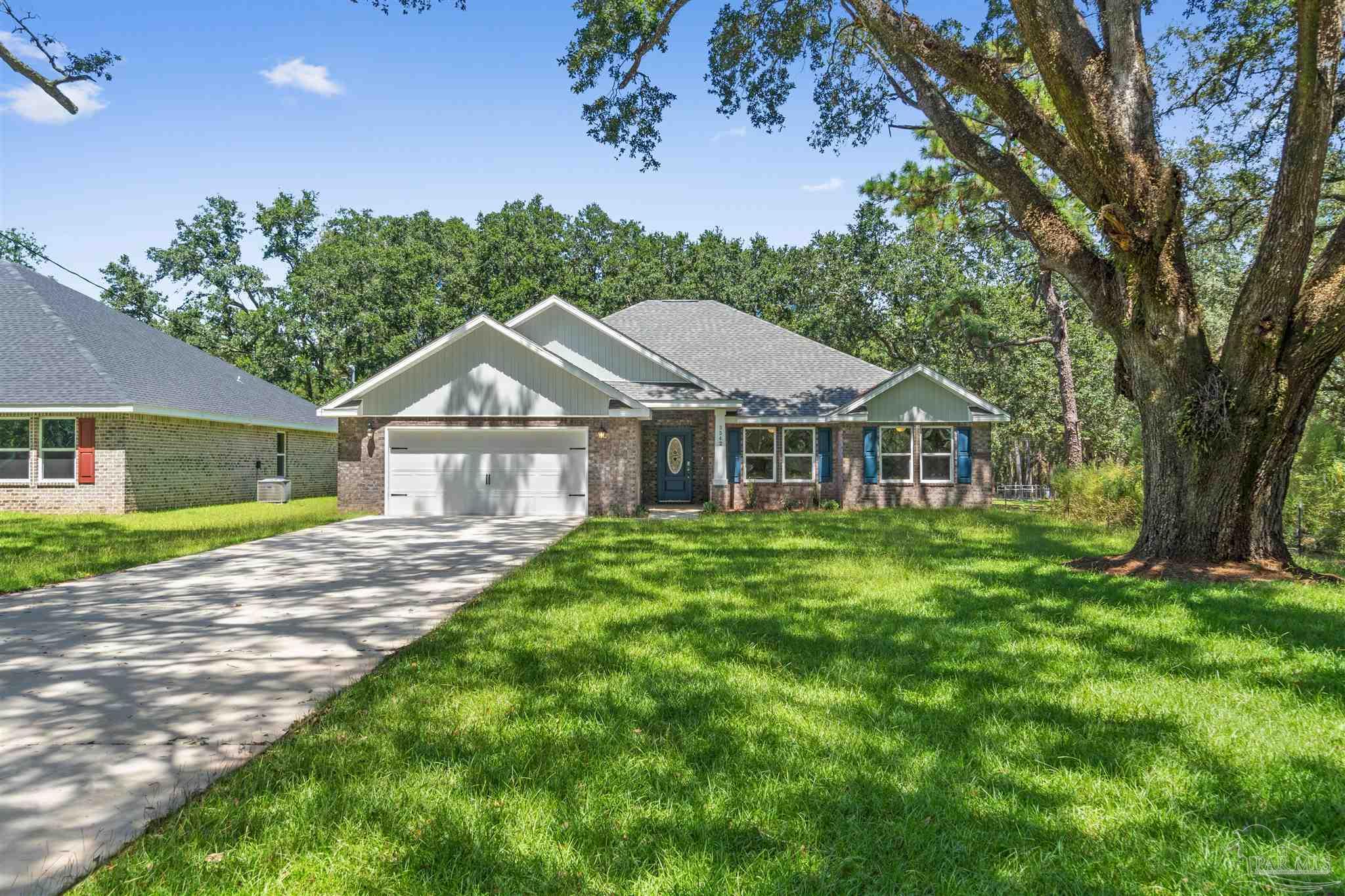 4289 Carl Booker Road Milton, FL 32583 - Photo 2 of 40 a front view of a house with a yard