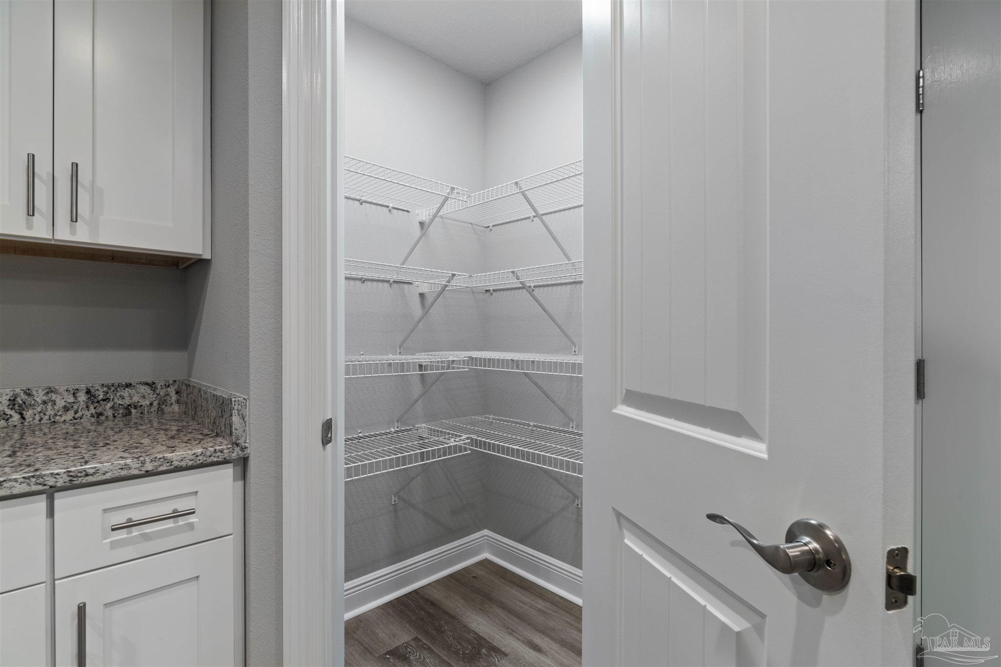 4289 Carl Booker Road Milton, FL 32583 - Photo 21 of 40 a bathroom with a granite countertop sink and white cabinets