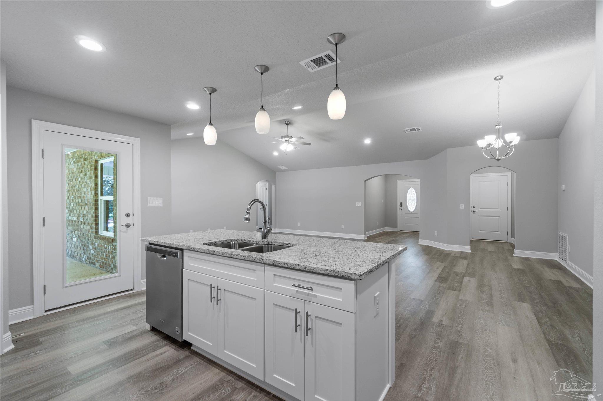 4289 Carl Booker Road Milton, FL 32583 - Photo 22 of 40 a kitchen with a sink chandelier and wooden floor