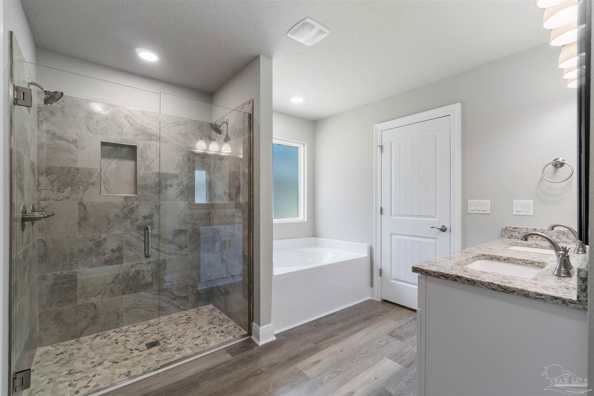 4289 Carl Booker Road Milton, FL 32583 - Photo 27 of 40 a bathroom with a bathtub and a shower