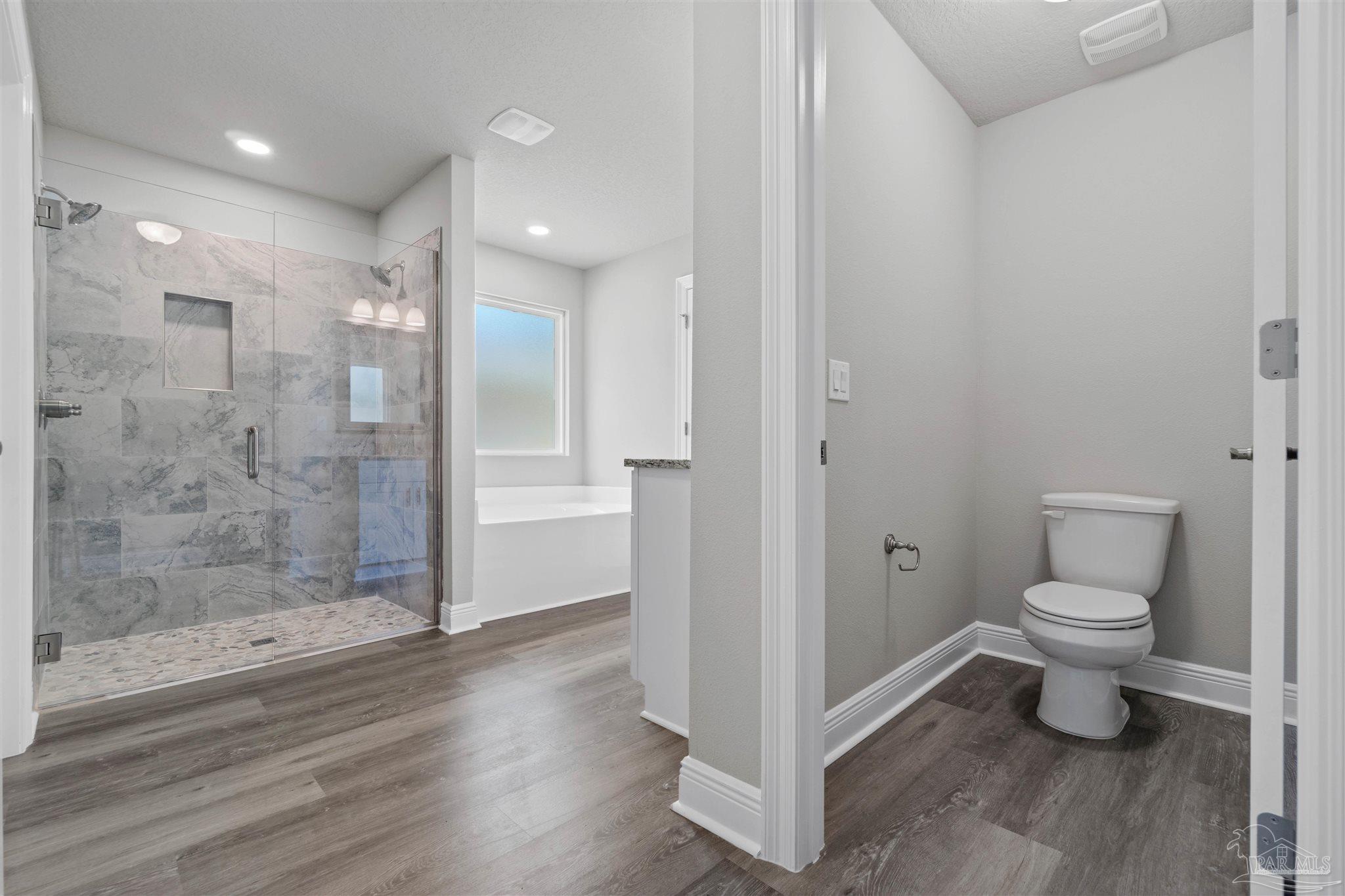 4289 Carl Booker Road Milton, FL 32583 - Photo 29 of 40 a bathroom with a toilet a sink and shower