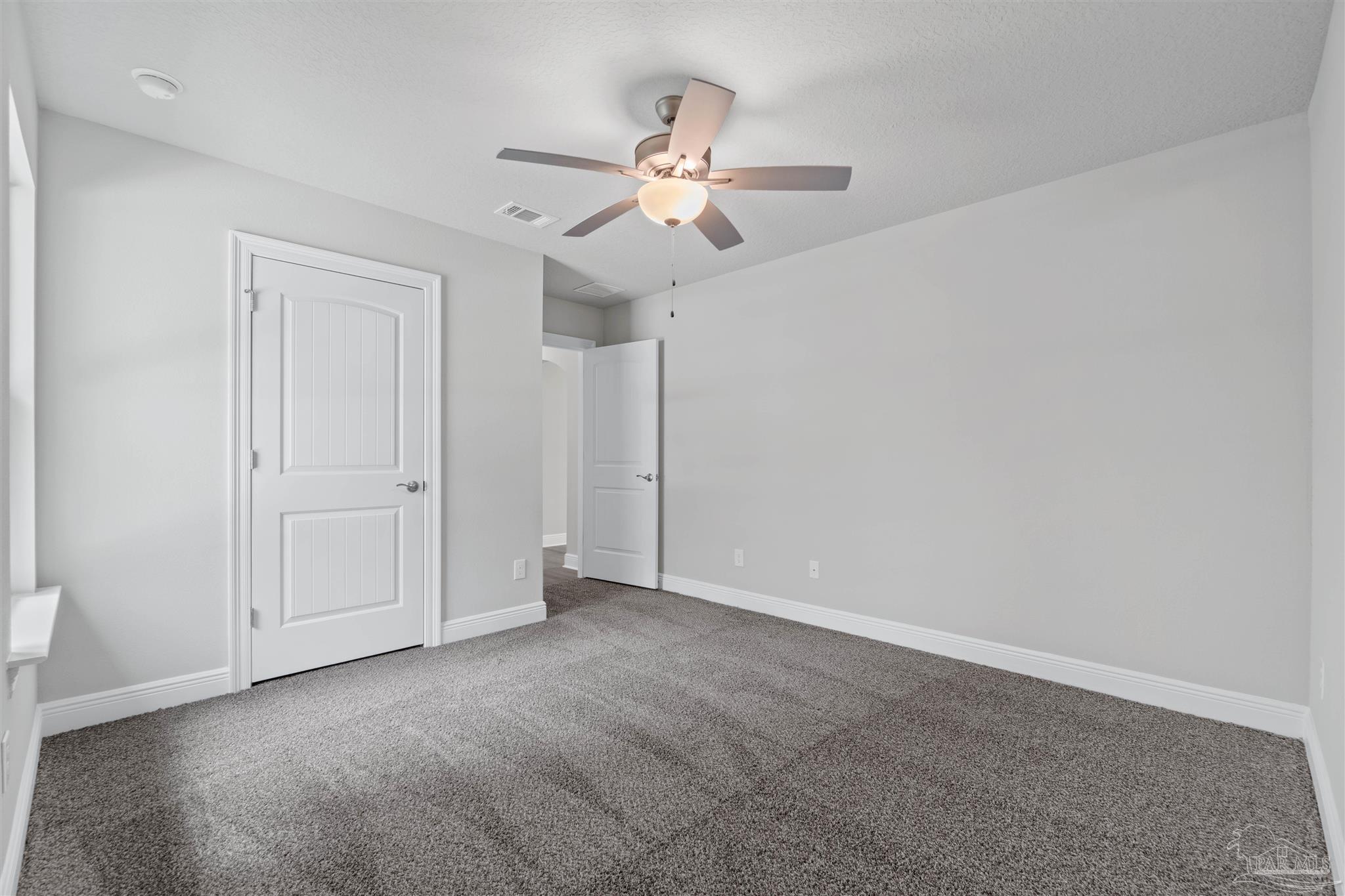 4289 Carl Booker Road Milton, FL 32583 - Photo 33 of 40 a view of an empty room with a ceiling fan