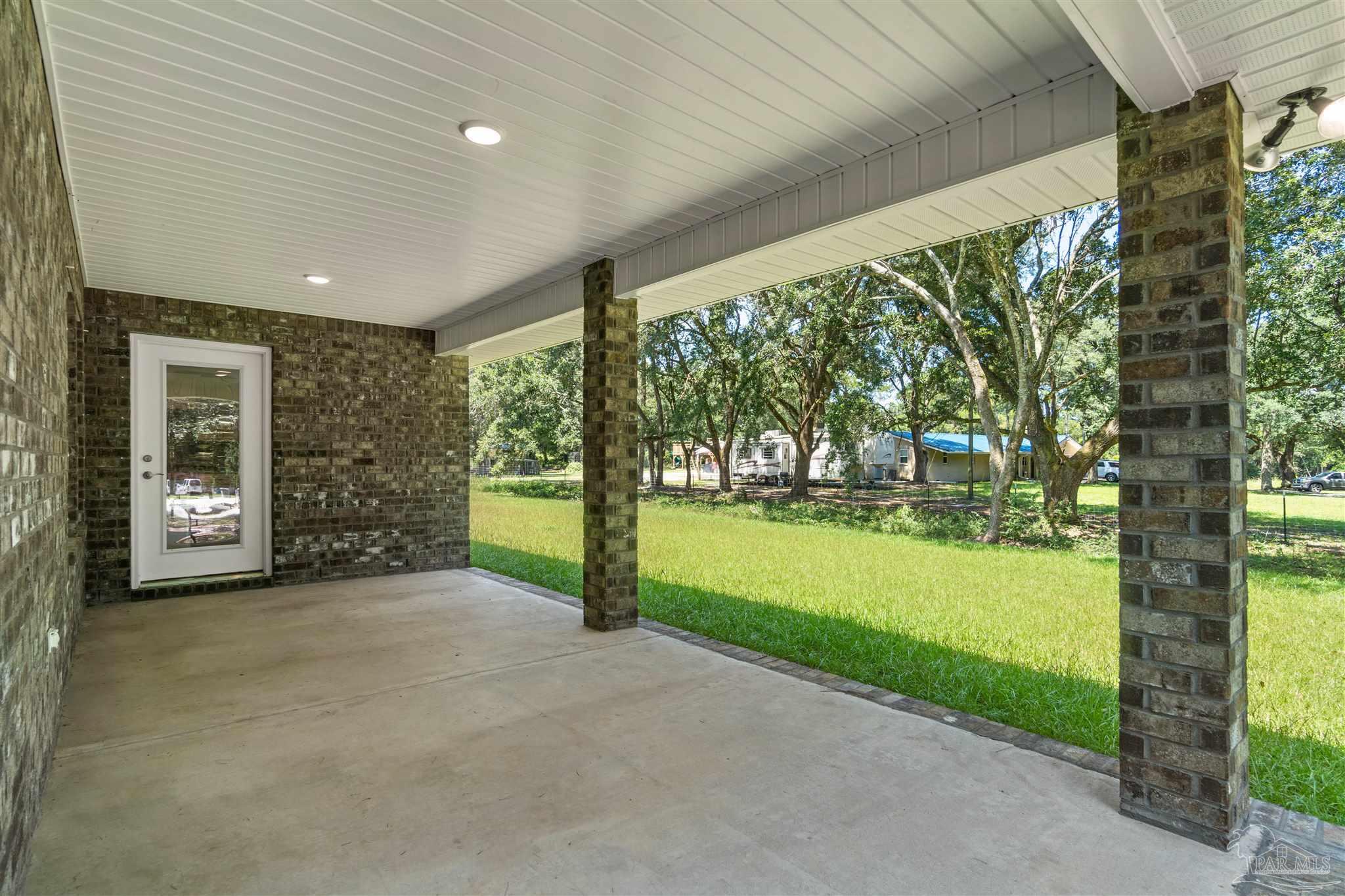 4289 Carl Booker Road Milton, FL 32583 - Photo 40 of 40 a view of an house with backyard and garden