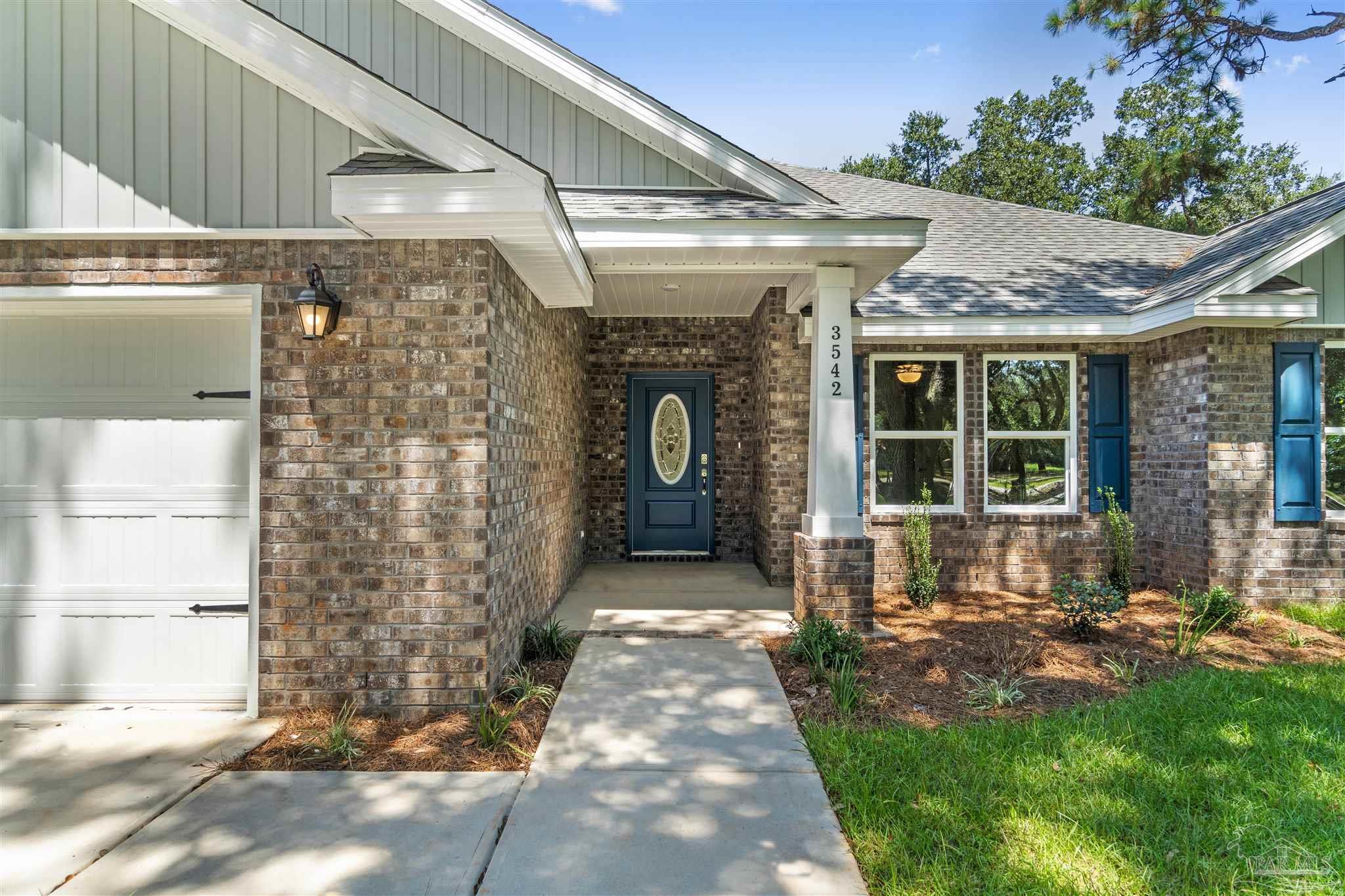 4289 Carl Booker Road Milton, FL 32583 - Photo 4 of 40 a front view of a house with a yard