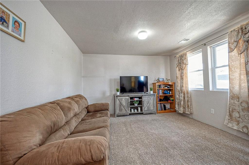 249 Washington Road, Unit 3 Waynesburg, PA 15370 - Photo 2 of 10 a living room with furniture and a flat screen tv
