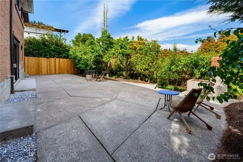 a view of a backyard with furniture and a garden