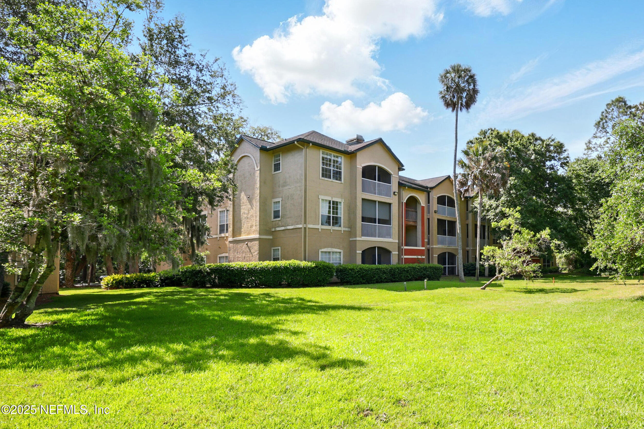 150 Veracruz Drive, Unit 537 Ponte Vedra Beach, FL 32082 - Photo 3 of 14 a view of a house with a big yard and large trees