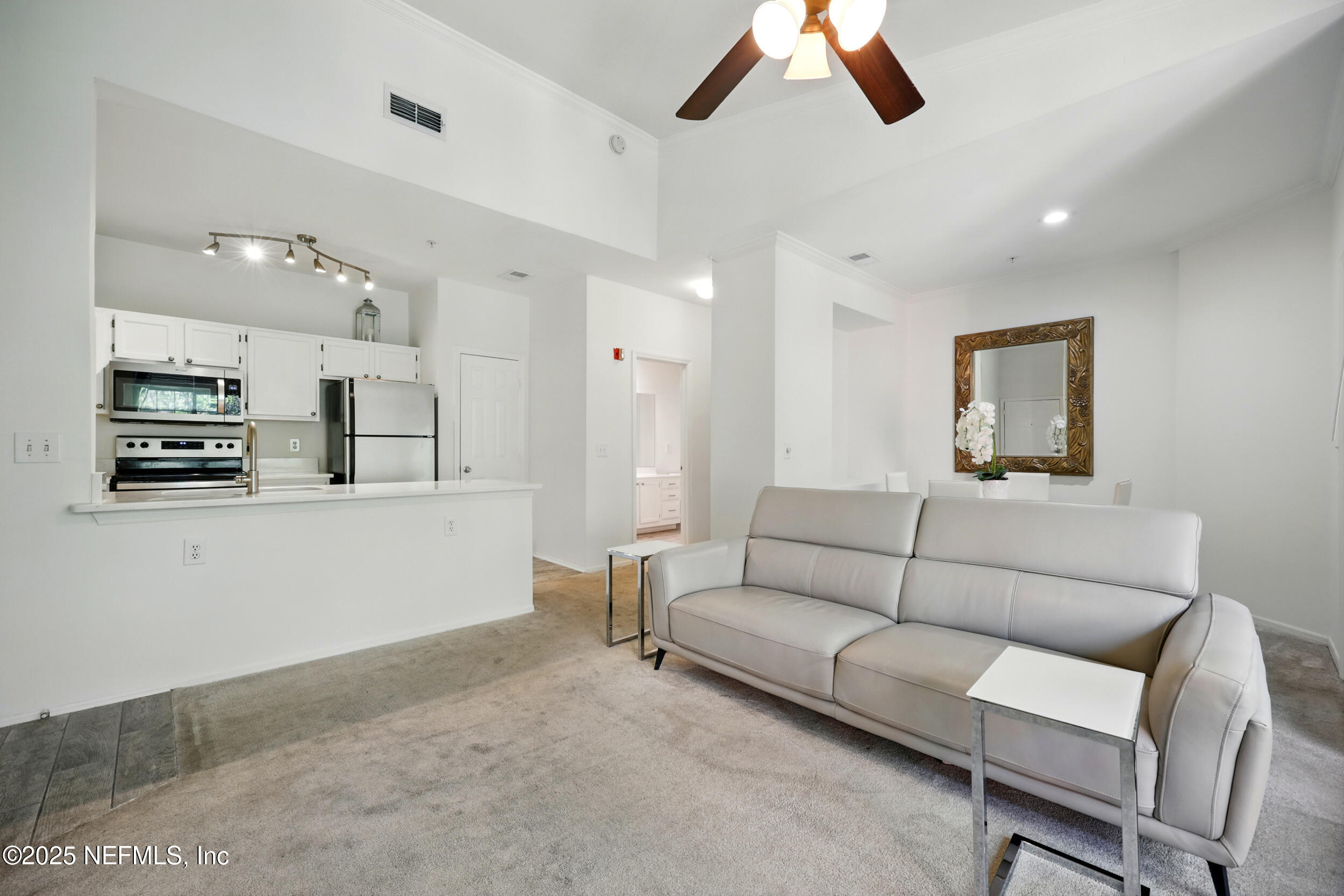 150 Veracruz Drive, Unit 537 Ponte Vedra Beach, FL 32082 - Photo 4 of 14 a living room with furniture and a flat screen tv