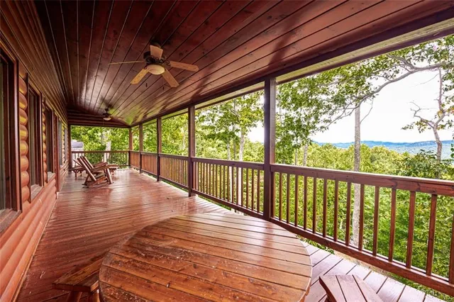 a view of a patio with couches chairs and wooden floor