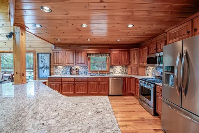 a bathroom with a granite countertop sink a toilet and shower