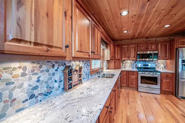 a bathroom with a tub sink shower and mirror