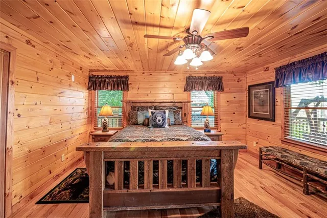 a bedroom with a bed next to a window with outer view