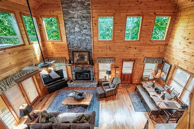 a living room with couches bookshelf and a flat screen tv