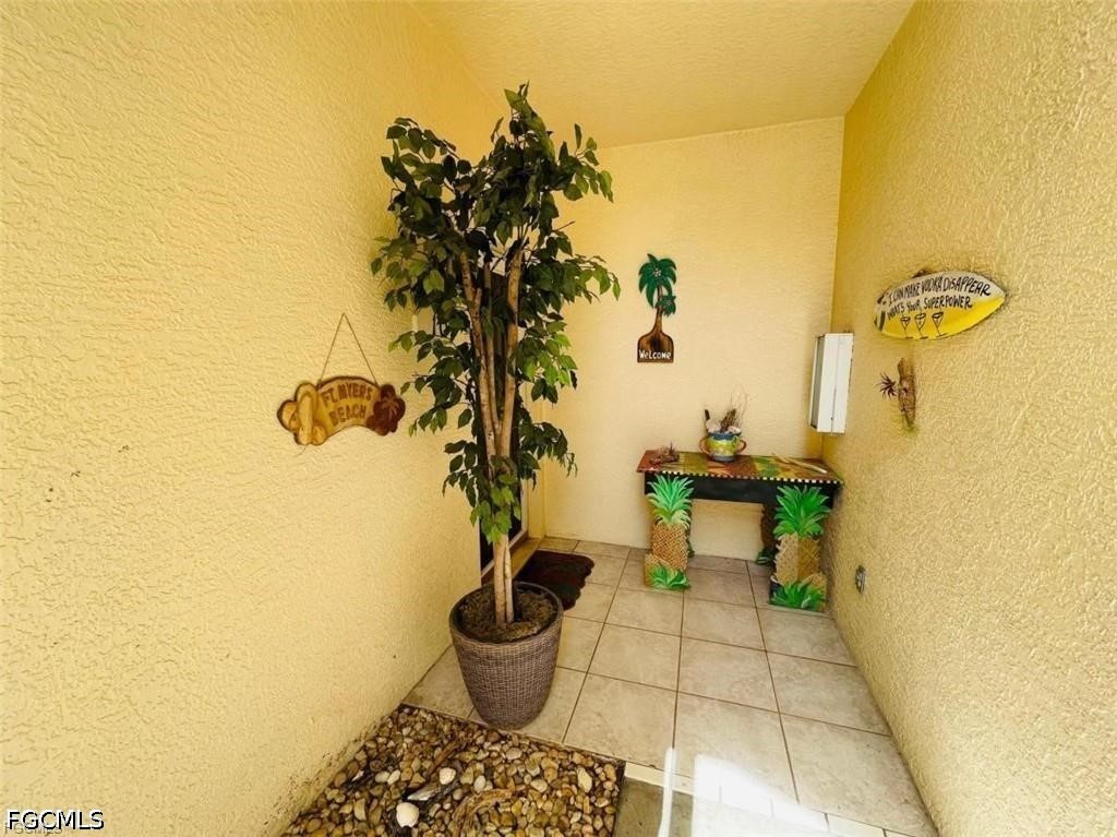 14971 Rivers Edge Court, Unit 101 Fort Myers, FL 33908 - Photo 3 of 9 a view of a porch with plants and potted plants