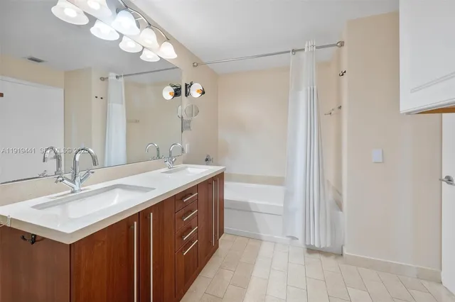 a bathroom with a sink a mirror and a shower