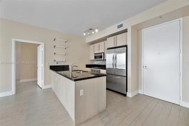 a kitchen with a refrigerator a sink and a stove