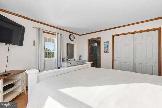 a bedroom with a bed and a flat screen tv