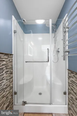 a bathroom with a glass shower door