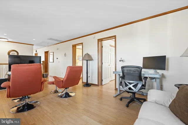 a view of a livingroom with workspace and a couch