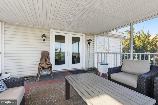 a balcony with furniture and a potted plant