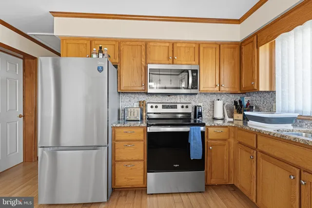 a kitchen with a refrigerator sink and microwave