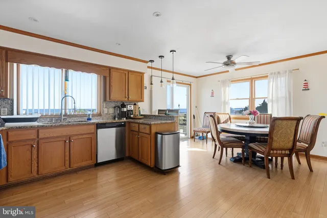 a kitchen with a table chairs sink and cabinets