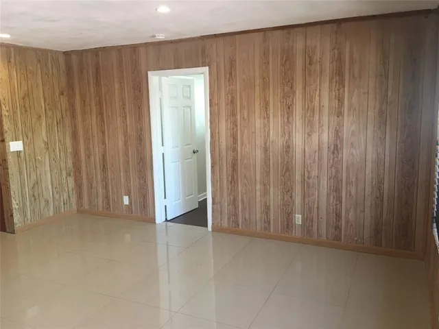 a view of a closet with wooden walls