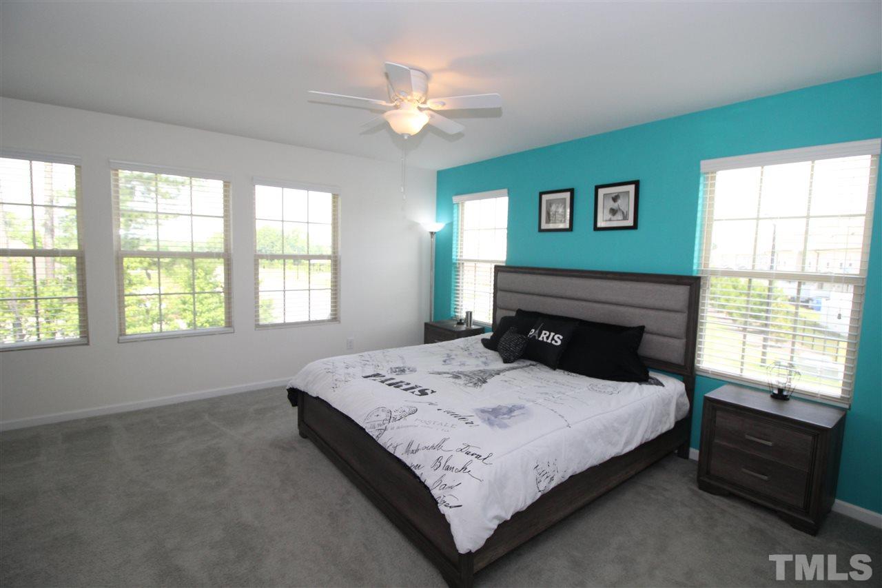 1045 Grand Ridge Drive Rolesville, NC 27571 - Photo 12 of 23 a bedroom with a bed and a window