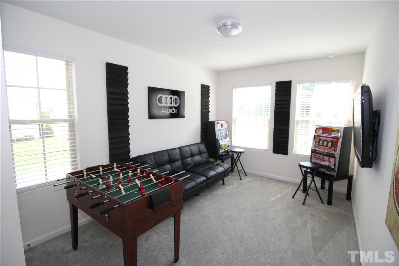 1045 Grand Ridge Drive Rolesville, NC 27571 - Photo 20 of 23 a living room with furniture and a flat screen tv