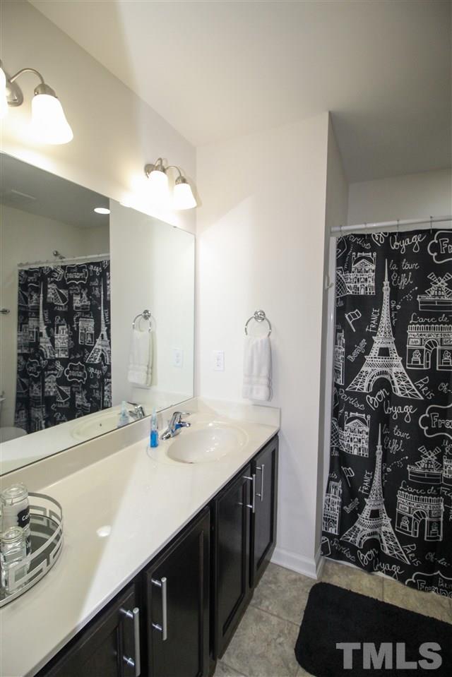1045 Grand Ridge Drive Rolesville, NC 27571 - Photo 22 of 23 a bathroom with a sink vanity and a mirror