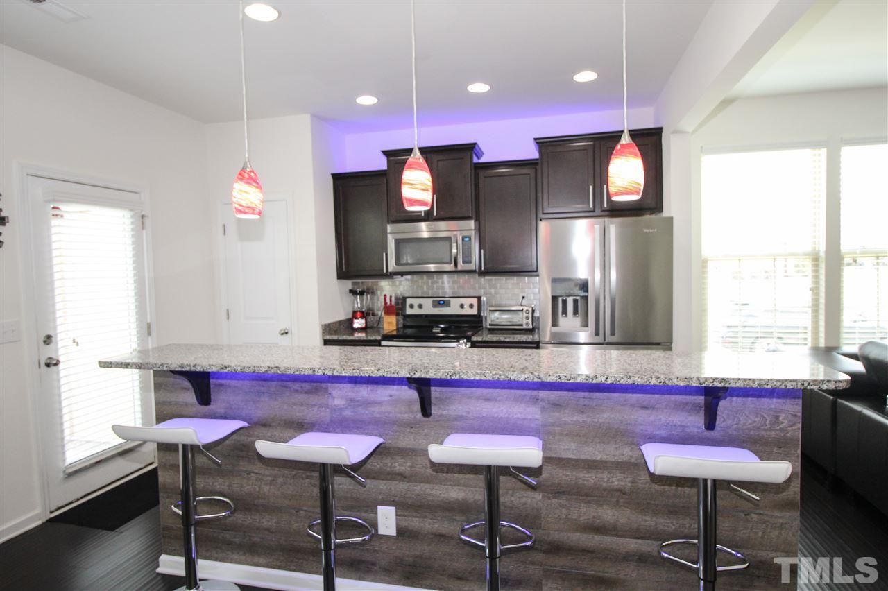 1045 Grand Ridge Drive Rolesville, NC 27571 - Photo 9 of 23 a kitchen with cabinets and chairs