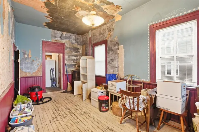 a view of a dining room with furniture large window and wooden floor