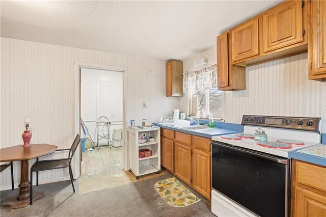 a kitchen that has a sink and a stove in it