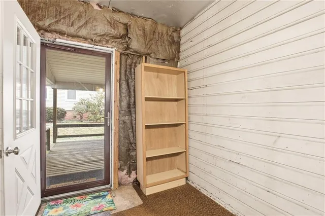 a view of an empty room and a window