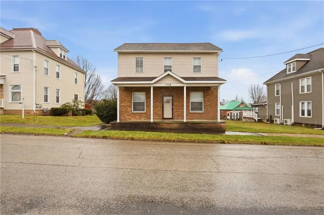 a front view of a house with a yard