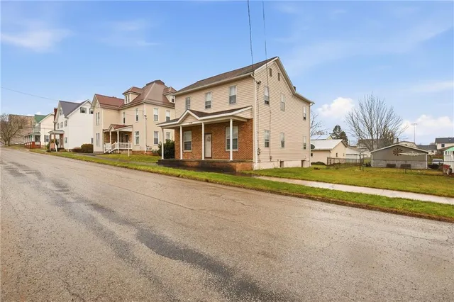 a view of a white house with a swimming pool