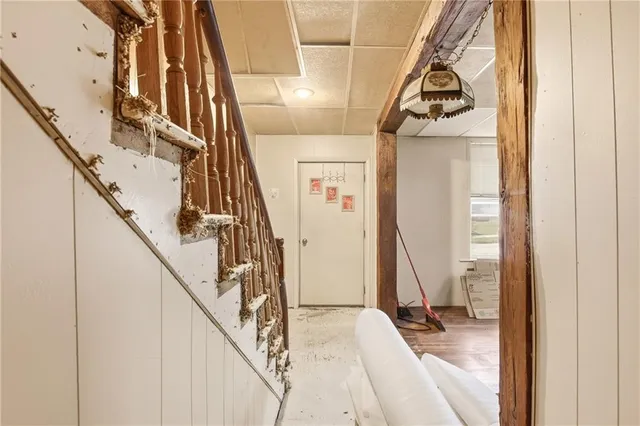 a view of staircase with railing and white walls