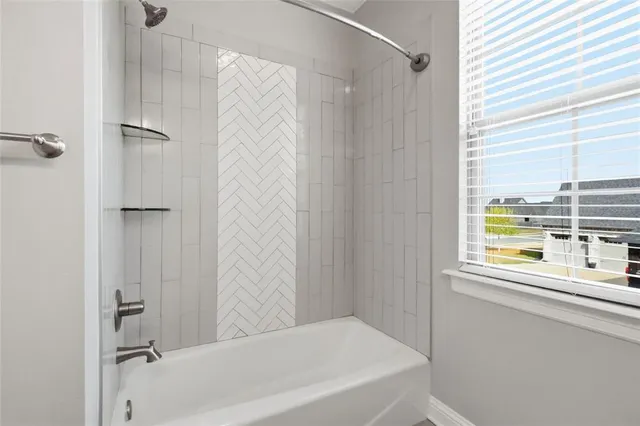 a bathroom with a bathtub and a shower