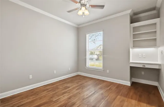 wooden floor in an empty room with a window